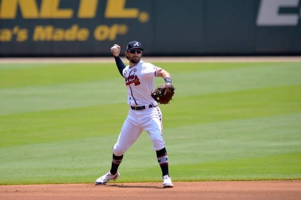 Dansby Swanson of the Atlanta Braves throws to first base to end the top of the first inning against the Miami Marlins at Truist Park on July 4, 2021...