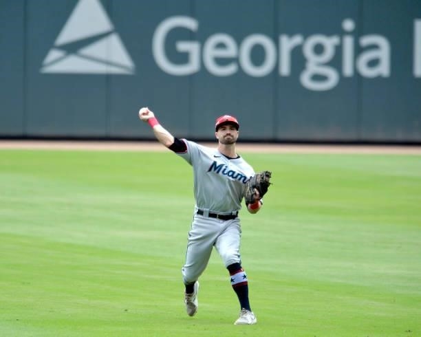 Adam Duvall of the Miami Marlins throws to first base in the bottom of the first inning against the Atlanta Braves at Truist Park on July 4, 2021 in...