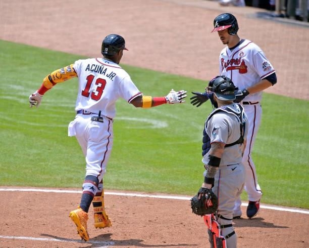 Ronald Acuña Jr. #13 of the Atlanta Braves celebrates with Charlie Morton after hitting a two run homer in the third inning against the Miami Marlins...