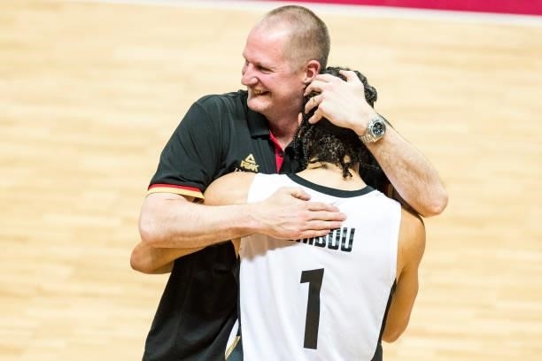 Germanys head coach Henrik Rodl reacts with Joshiko Saibou of Germany after winning the 2020 FIBA Men's Olympic Qualifying Tournament final between...