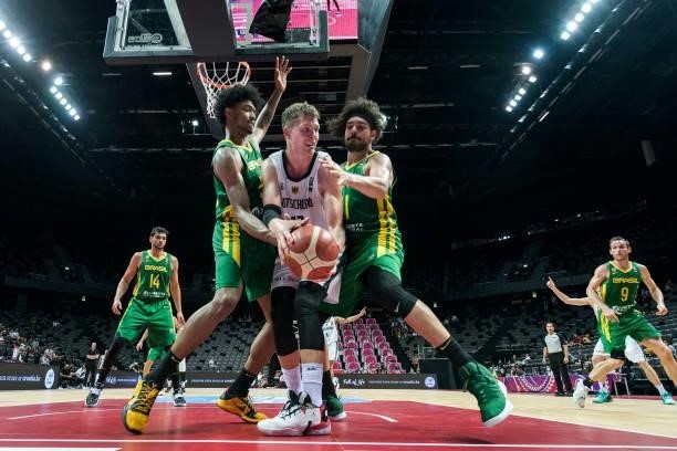 Moritz Wagner of Germany fighting for the ball against Bruno Caboclo and Leonardo Meindl of Brazil during the 2020 FIBA Men's Olympic Qualifying...