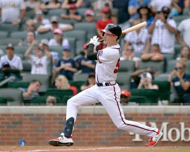 Max Fried of the Atlanta Braves hits a single to score the winning run in the tenth inning against the Miami Marlins at Truist Park on July 4, 2021...