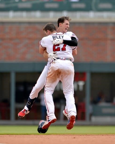 Max Fried and Austin Riley of the Atlanta Braves celebrate after winning against the Miami Marlins at Truist Park on July 4, 2021 in Atlanta, Georgia.