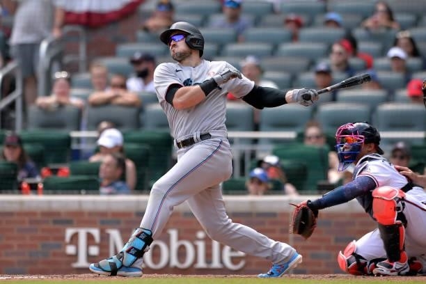 Adam Duvall of the Miami Marlins hits a double in the eighth inning against the Atlanta Braves at Truist Park on July 4, 2021 in Atlanta, Georgia.