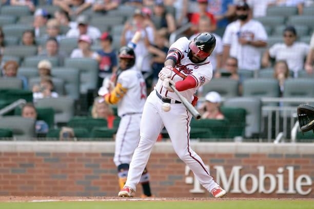 Abraham Almonte of the Atlanta Braves makes a base hit in the ninth inning against the Miami Marlins at Truist Park on July 4, 2021 in Atlanta,...