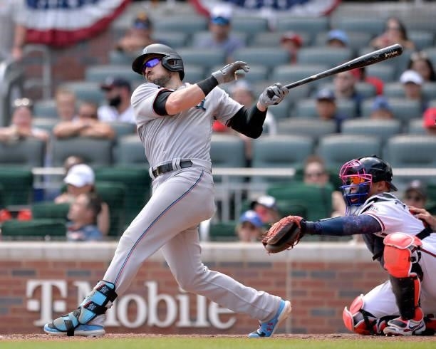 Adam Duvall of the Miami Marlins hits a double in the eighth inning against the Atlanta Braves at Truist Park on July 4, 2021 in Atlanta, Georgia.