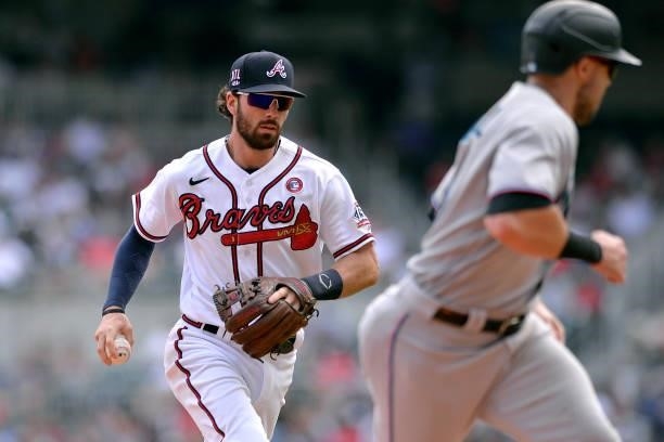 Dansby Swanson of the Atlanta Braves chases down Adam Duvall of the Miami Marlins in the eighth inning at Truist Park on July 4, 2021 in Atlanta,...
