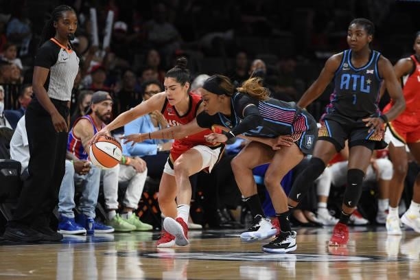 Kelsey Plum of the Las Vegas Aces and Odyssey Sims of the Atlanta Dream reach for the ball during the game on July 4, 2021 at Michelob ULTRA Arena in...