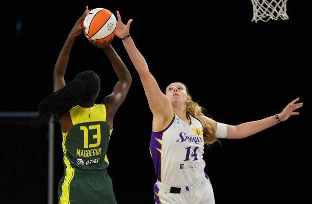 Lauren Cox of the Los Angeles Sparks blocks a shot by Ezi Magbegor of the Seattle Storm in the first half at the Los Angeles Convention Center on...