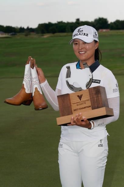 Jin Young Ko of Korea poses with the trophy and cowboy boots after winning the Volunteers of America Classic at the Old American Golf Club on July 4,...