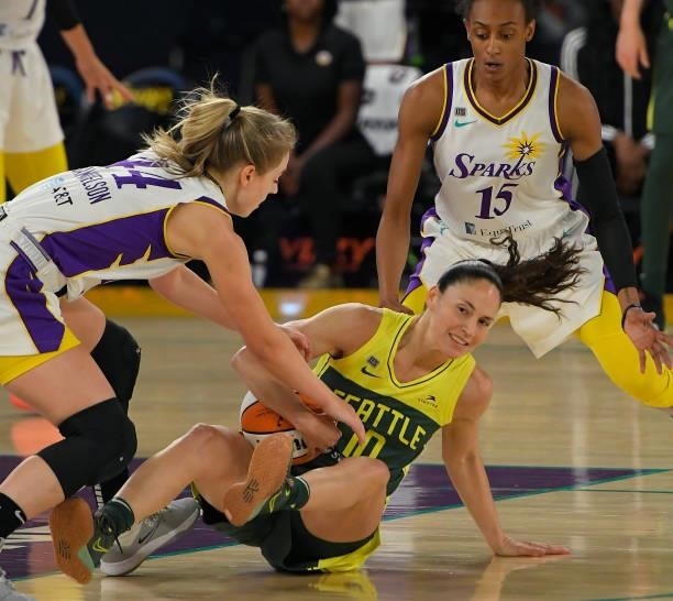 Sue Bird of the Seattle Storm protects the ball from Karlie Samuelson of the Los Angeles Sparks and Brittney Sykes of the Los Angeles Sparks in the...