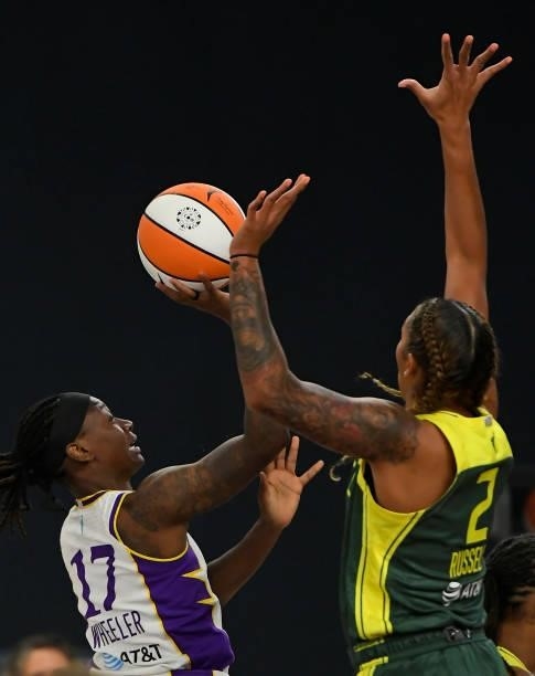 Erica Wheeler of the Los Angeles Sparks is blocked by Mercedes Russell of the Seattle Storm in the first half at the Los Angeles Convention Center on...