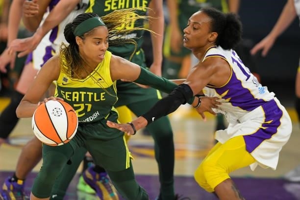 Jordin Canada of the Seattle Storm tries to get around Brittney Sykes of the Los Angeles Sparks at the Los Angeles Convention Center on July 4, 2021...