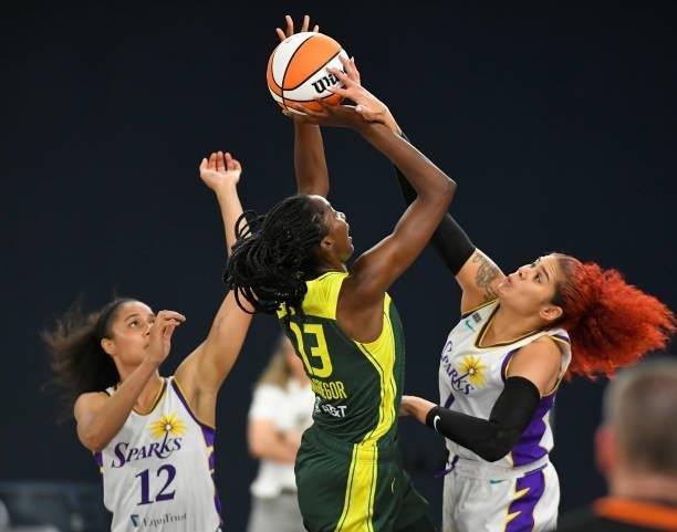 Nia Coffey looks on as Amanda Zahui B of the Los Angeles Sparks blocks a shot by Ezi Magbegor of the Seattle Storm at the Los Angeles Convention...