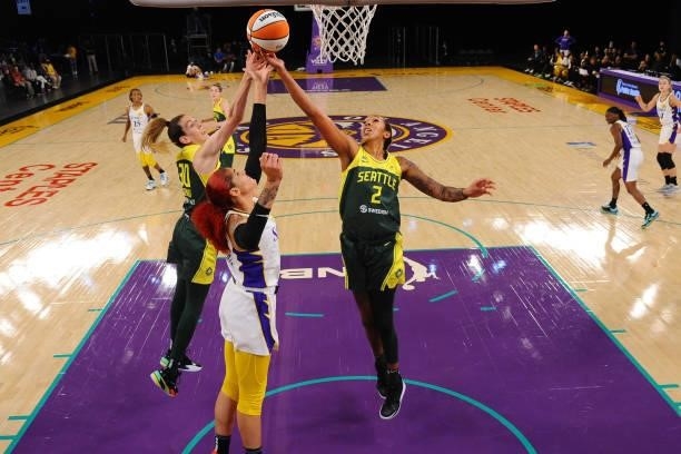 Breanna Stewart and Mercedes Russell of the Seattle Storm reach for the rebound against Amanda Zahui B of the Los Angeles Sparks during the game on...