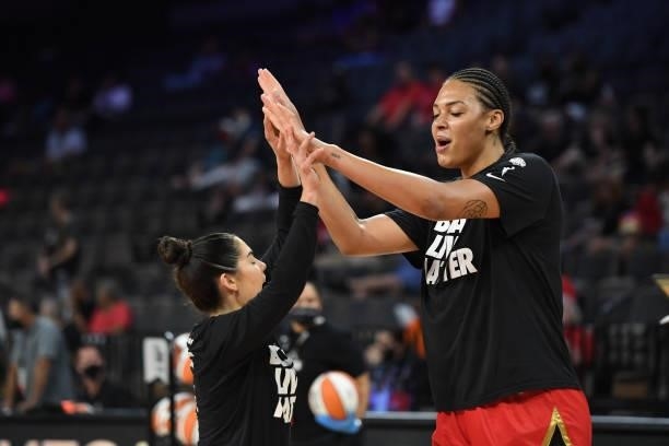 Kelsey Plum and Liz Cambage of the Las Vegas Aces high five before the game against the Atlanta Dream on July 4, 2021 at Michelob ULTRA Arena in Las...