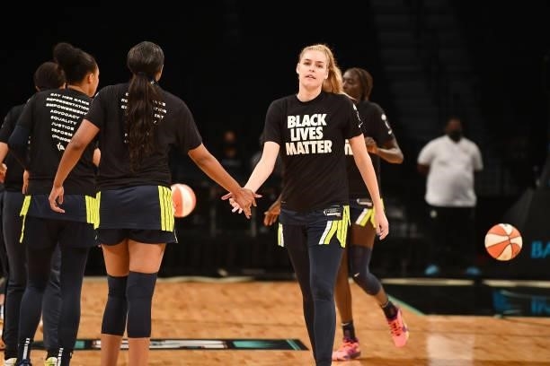 Bella Alarie of the Dallas Wings high fives teammate before the game against the New York Liberty on July 5, 2021 at the Barclays Center in Brooklyn,...