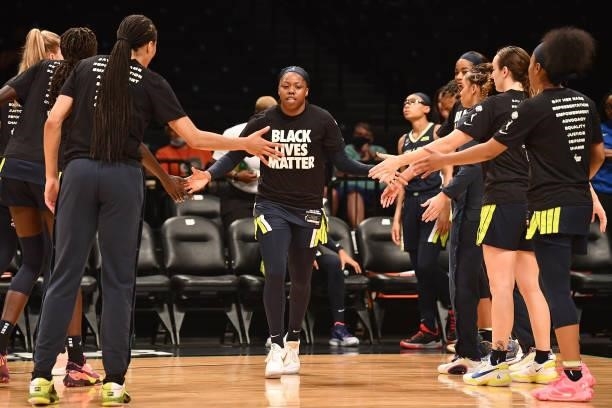 Arike Ogunbowale of the Dallas Wings high fives teammates before the game against the New York Liberty on July 5, 2021 at the Barclays Center in...