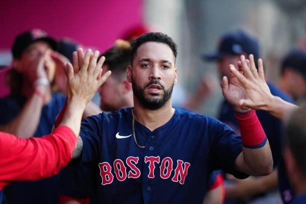 Marwin Gonzalez of the Boston Red Sox celebrates in the dugout after scoring during the game between the Boston Red Sox and the Los Angeles Angels at...