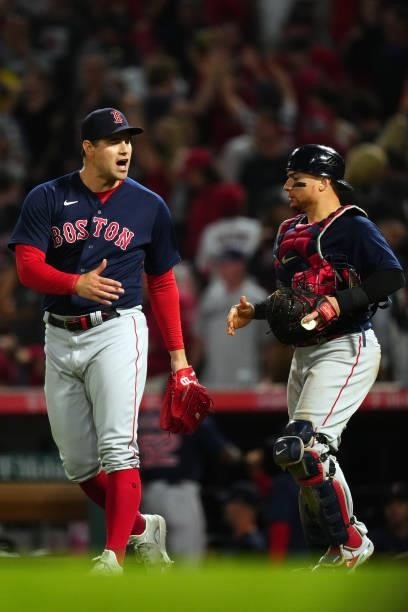 Adam Ottavino of the Boston Red Sox celebrates with Christian Vázquez after the game between the Boston Red Sox and the Los Angeles Angels at Angel...