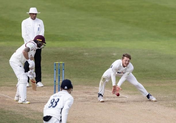 Dominic Bess of Yorkshire fields off of his own bowling during day three of the LV= Insurance County Championship match between Northamptonshire and...