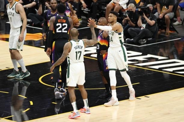 Tucker hi-fives Giannis Antetokounmpo of the Milwaukee Bucks during Game One of the 2021 NBA Finals on July 6, 2021 at Phoenix Suns Arena in Phoenix,...