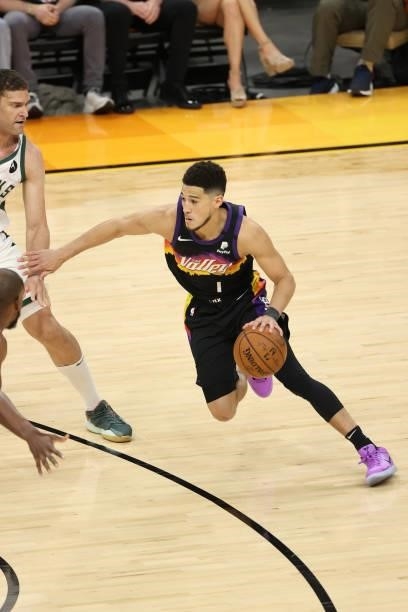 Devin Booker of the Phoenix Suns dribbles the ball during Game One of the 2021 NBA Finals on July 6, 2021 at Phoenix Suns Arena in Phoenix, Arizona....