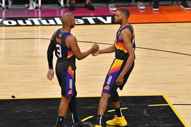 Chris Paul and Mikal Bridges of the Phoenix Suns shake hands against the Milwaukee Bucks during Game One of the 2021 NBA Finals on July 6, 2021 at...