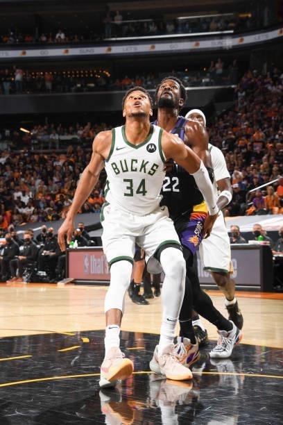 Giannis Antetokounmpo of the Milwaukee Bucks and Deandre Ayton of the Phoenix Suns fight for position during Game One of the 2021 NBA Finals on July...