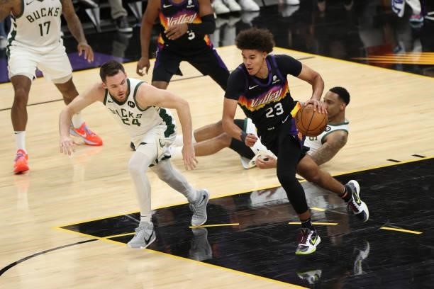 Cameron Johnson of the Phoenix Suns dribbles the ball during Game One of the 2021 NBA Finals on July 6, 2021 at Phoenix Suns Arena in Phoenix,...