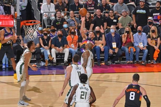 Devin Booker of the Phoenix Suns shoots the ball while fading away against the Milwaukee Bucks during Game One of the 2021 NBA Finals on July 6, 2021...