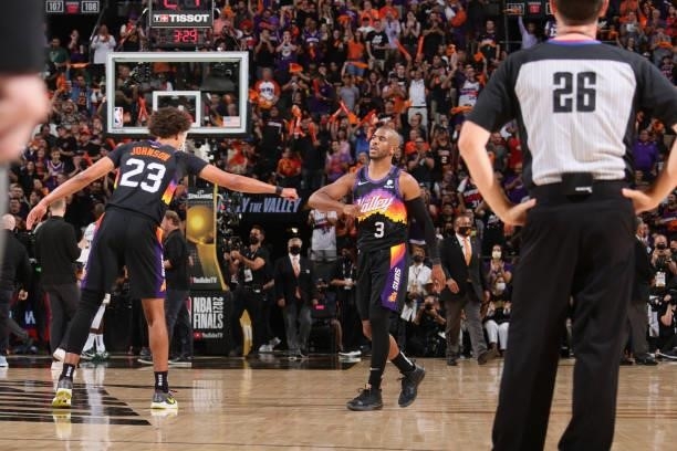 Cameron Johnson of the Phoenix Suns high fives Chris Paul of the Phoenix Suns during Game One of the 2021 NBA Finals on July 6, 2021 at Talking Stick...