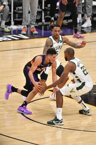 Devin Booker of the Phoenix Suns drives to the basket around Khris Middleton of the Milwaukee Bucks during Game One of the 2021 NBA Finals on July 6,...