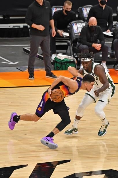Devin Booker of the Phoenix Suns drives to the basket around Jrue Holiday of the Milwaukee Bucks during Game One of the 2021 NBA Finals on July 6,...