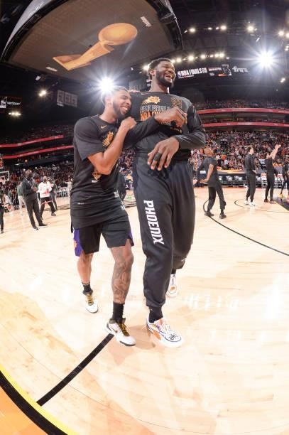 Cameron Payne of the Phoenix Suns and Deandre Ayton of the Phoenix Suns smile before the game against the Milwaukee Bucks during Game One of the 2021...