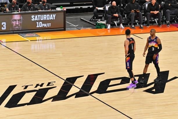 Devin Booker and Chris Paul of the Phoenix Suns talk at center court during Game One of the 2021 NBA Finalsagainst the Milwaukee Bucks on July 6,...
