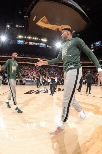 Giannis Antetokounmpo of the Milwaukee Bucks high fives Khris Middleton of the Milwaukee Bucks before the game against the Phoenix Suns during Game...