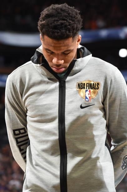 Giannis Antetokounmpo of the Milwaukee Bucks listens to the national anthem before the game against the Phoenix Suns during Game One of the 2021 NBA...