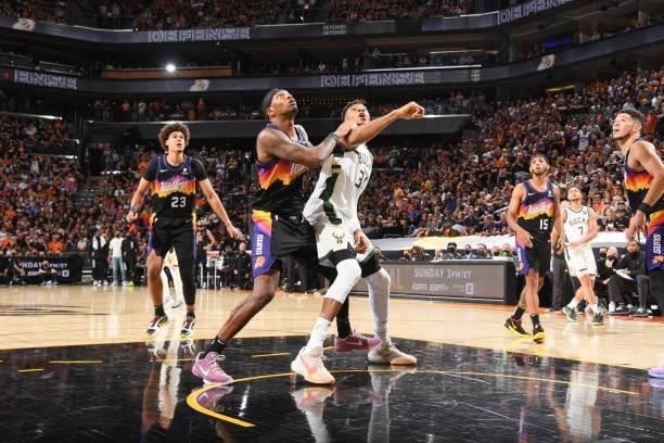 Torrey Craig of the Phoenix Suns and Giannis Antetokounmpo of the Milwaukee Bucks fight for position during Game One of the 2021 NBA Finals on July...