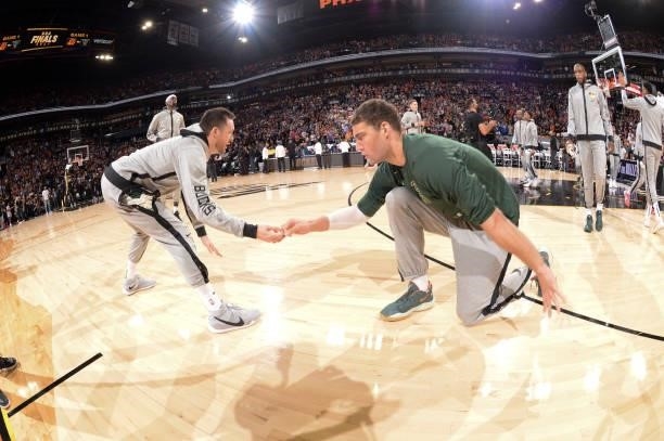 Pat Connaughton of the Milwaukee Bucks high fives Brook Lopez of the Milwaukee Bucks before the game against the Phoenix Suns during Game One of the...