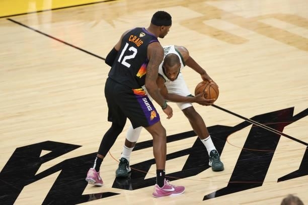 Torrey Craig of the Phoenix Suns plays defense on Khris Middleton of the Milwaukee Bucks during Game One of the 2021 NBA Finals on July 6, 2021 at...