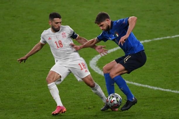 Domenico Berardi of Italy and Jordi Alba of Spain compete for the ball during the UEFA Euro 2020 Championship Semi-final match between Italy and...