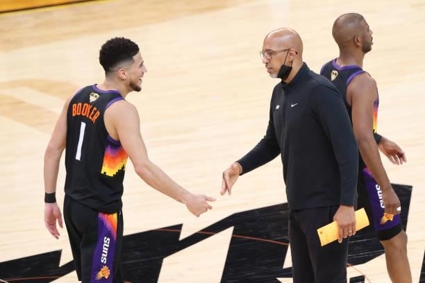 Head Coach Monty Williams of the Phoenix Suns hi-fives Devin Booker during Game One of the 2021 NBA Finals on July 6, 2021 at Phoenix Suns Arena in...