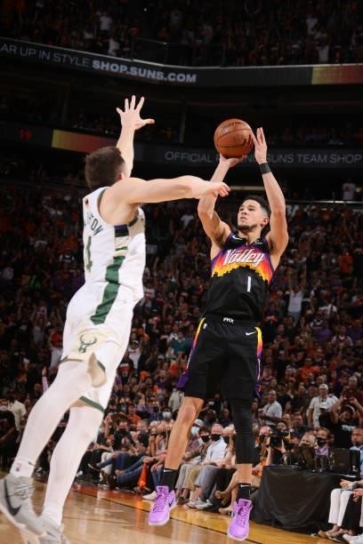 Devin Booker of the Phoenix Suns shoots a three point basket against the Milwaukee Bucks during Game One of the 2021 NBA Finals on July 6, 2021 at...