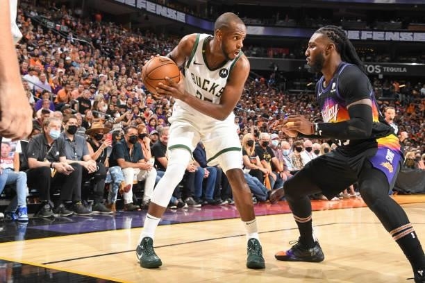 Khris Middleton of the Milwaukee Bucks handles the ball as Jae Crowder of the Phoenix Suns plays defense during Game One of the 2021 NBA Finals on...