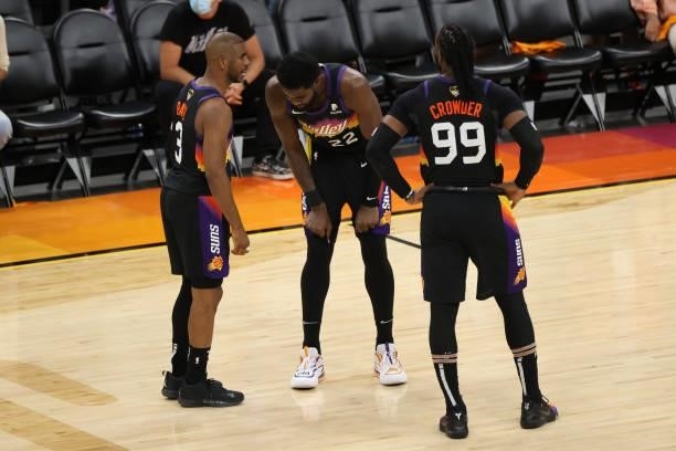 Deandre Ayton talks with Chris Paul and Jae Crowder of the Phoenix Suns during Game One of the 2021 NBA Finals on July 6, 2021 at Phoenix Suns Arena...
