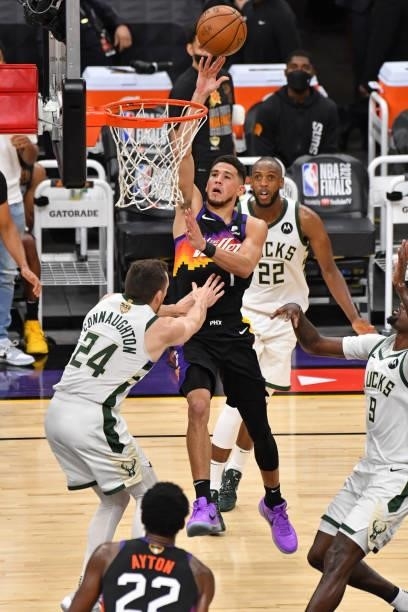 Devin Booker of the Phoenix Suns drives to the basket and shoots the ball against the Milwaukee Bucks during Game One of the 2021 NBA Finals on July...
