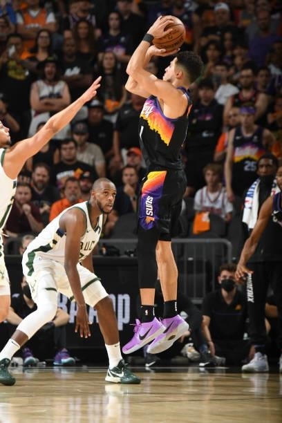 Devin Booker of the Phoenix Suns shoots a three point basket during the game against the Milwaukee Bucks during Game One of the 2021 NBA Finals on...