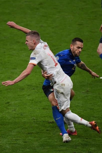 Rafael Tolol of Italy fouls Dani Olmo of Spain during the UEFA Euro 2020 Championship Semi-final match between Italy and Spain at Wembley Stadium on...