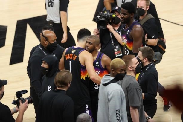 Chris Paul hugs Devin Booker of the Phoenix Suns after the game against the Milwaukee Bucks during Game One of the 2021 NBA Finals on July 6, 2021 at...
